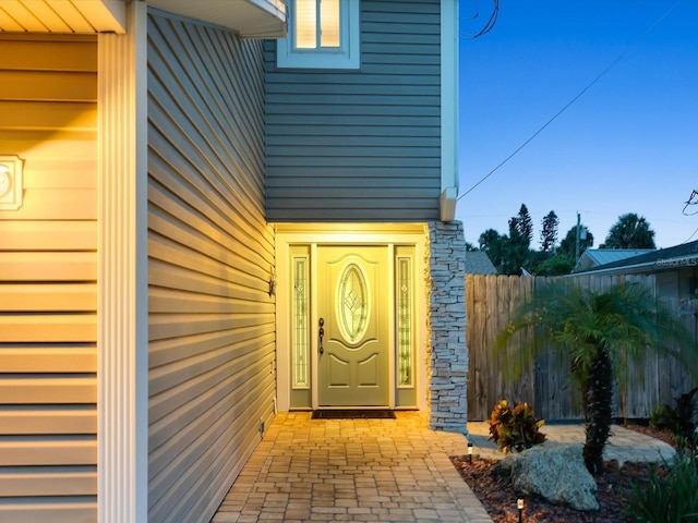 doorway to property with fence