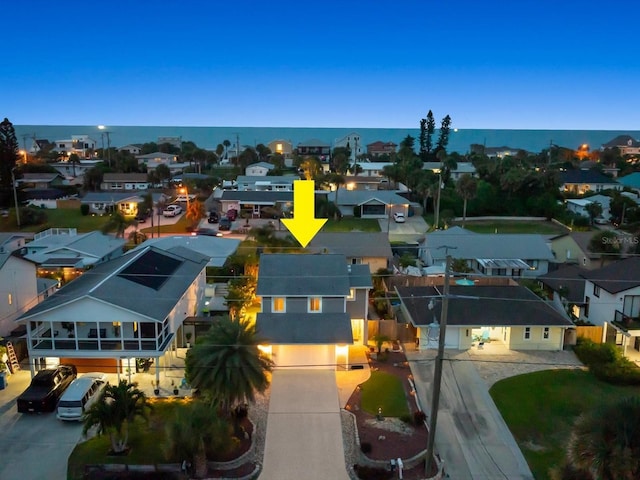 drone / aerial view featuring a water view and a residential view