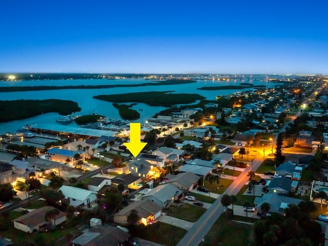 drone / aerial view featuring a water view and a residential view