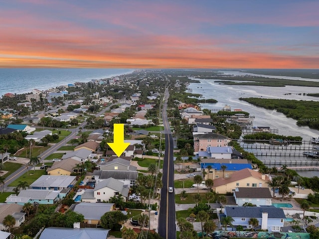 birds eye view of property featuring a water view and a residential view