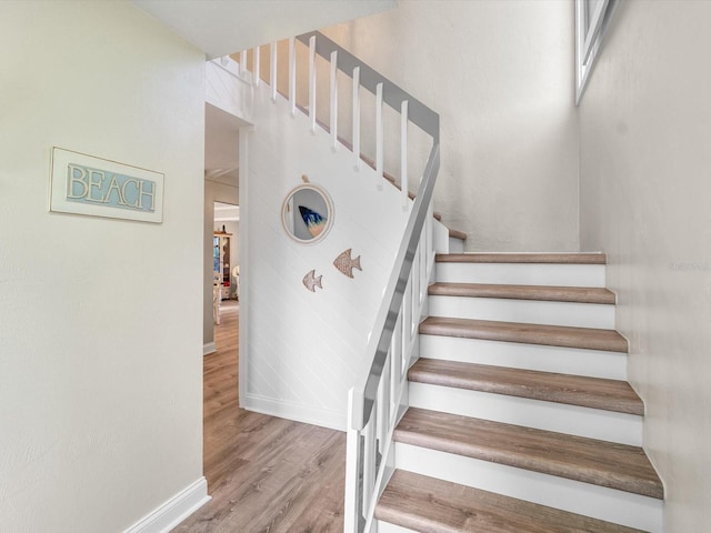 stairs with baseboards and wood finished floors