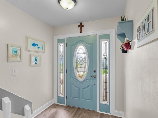 foyer with wood finished floors and baseboards