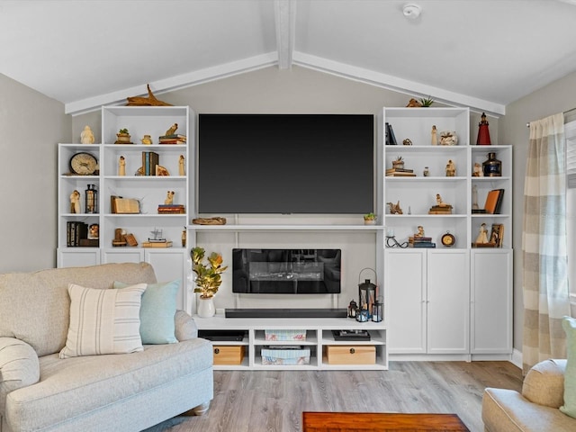 living room featuring lofted ceiling with beams and wood finished floors