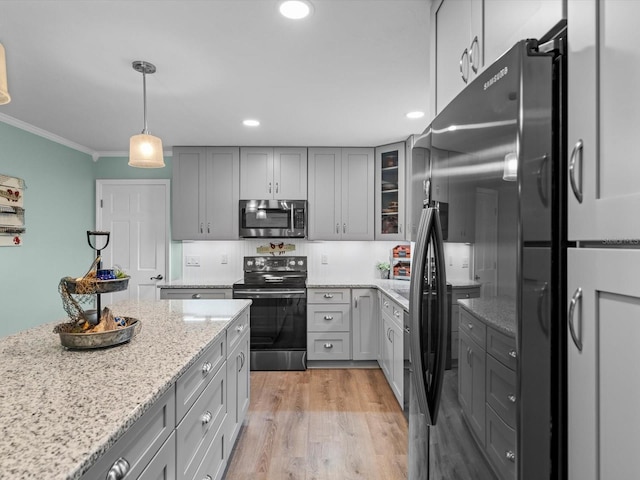 kitchen featuring electric stove, gray cabinets, freestanding refrigerator, stainless steel microwave, and crown molding