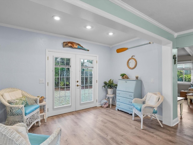 living area featuring recessed lighting, ornamental molding, wood finished floors, and french doors