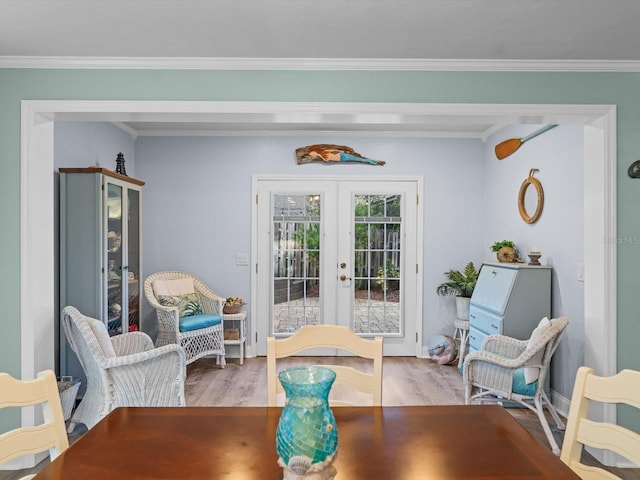 dining area featuring ornamental molding, wood finished floors, and french doors