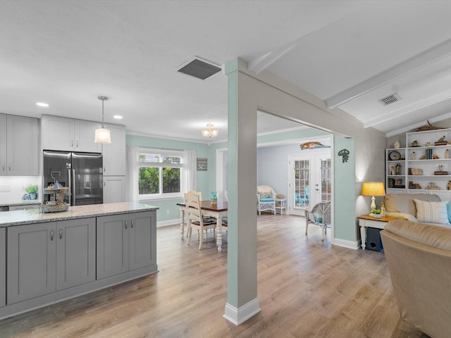 kitchen featuring gray cabinetry, visible vents, and stainless steel fridge with ice dispenser