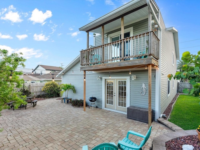 back of house with fence, a patio, and french doors