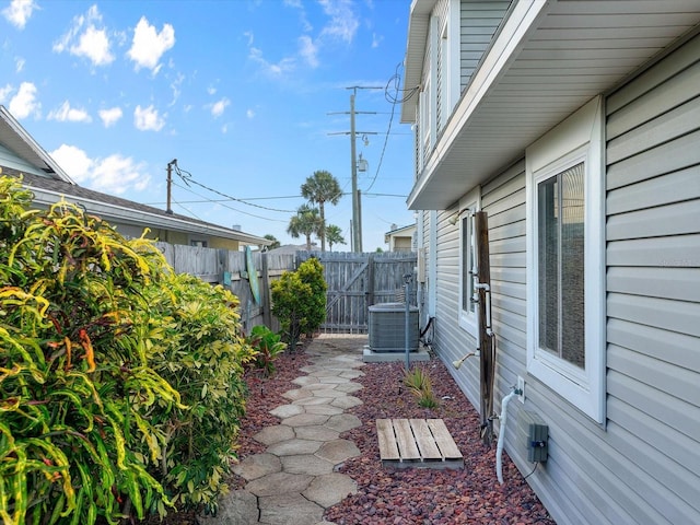 view of yard featuring fence and central AC unit