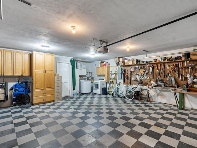 garage featuring a garage door opener, washer and clothes dryer, and a workshop area