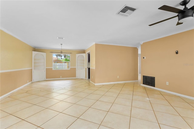 unfurnished room featuring ceiling fan with notable chandelier, light tile patterned floors, and crown molding