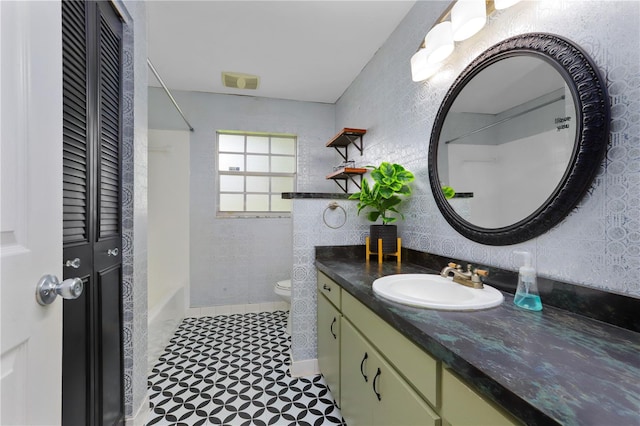 bathroom featuring toilet, tile patterned floors, and vanity