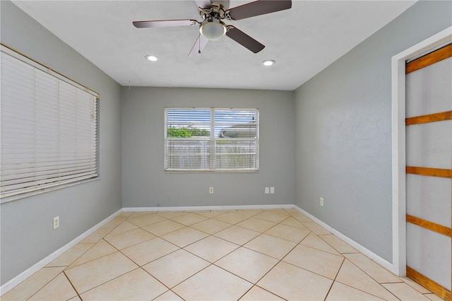 empty room featuring ceiling fan and light tile patterned floors