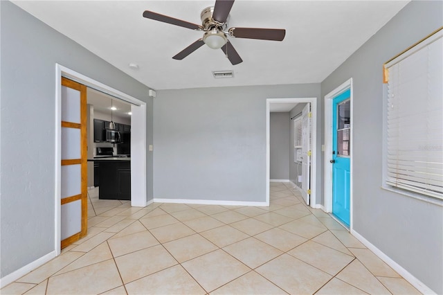 tiled empty room with ceiling fan