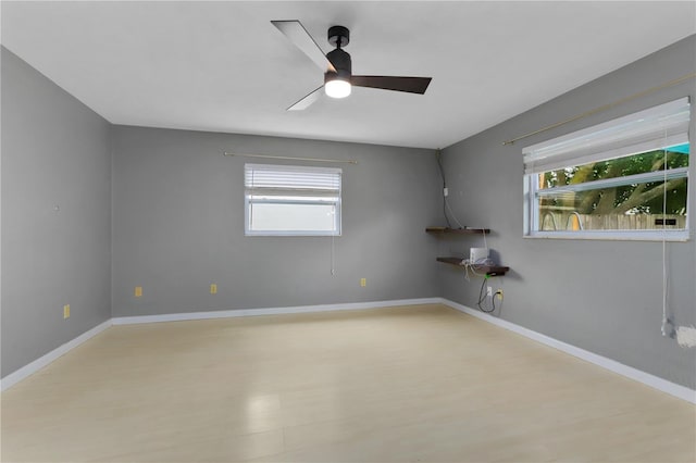 empty room featuring ceiling fan and light hardwood / wood-style flooring