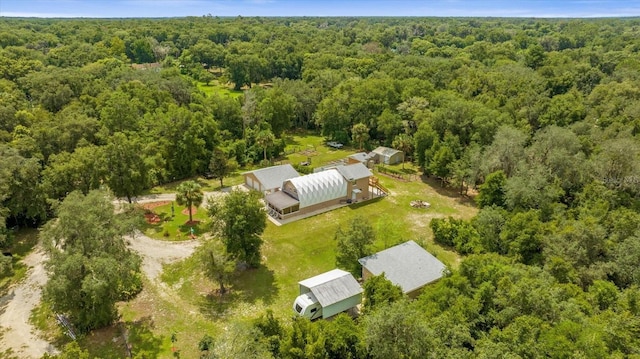 birds eye view of property featuring a wooded view