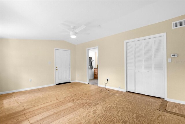 unfurnished bedroom featuring connected bathroom, ceiling fan, light wood-type flooring, and lofted ceiling