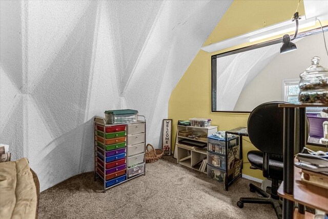 home office featuring lofted ceiling and carpet flooring