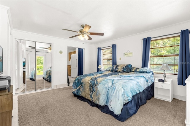 bedroom featuring baseboards, a ceiling fan, crown molding, and freestanding refrigerator