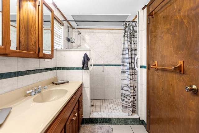 bathroom featuring tile walls, a shower with curtain, tile patterned floors, and vanity