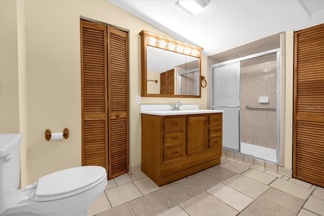 full bath with lofted ceiling, a closet, toilet, vanity, and tile patterned flooring