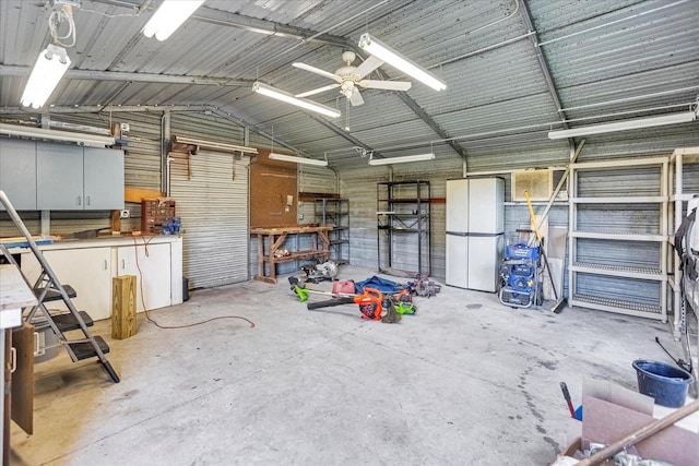 garage featuring ceiling fan and a workshop area