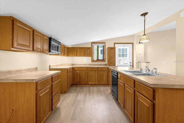 kitchen with hanging light fixtures, dishwasher, vaulted ceiling, light wood-type flooring, and sink