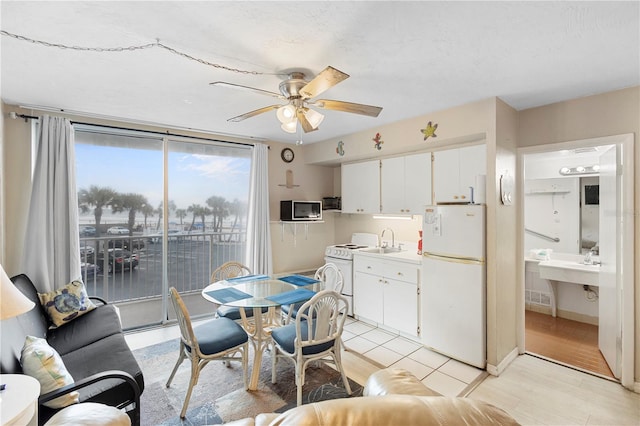 dining area with sink, ceiling fan, and light hardwood / wood-style floors