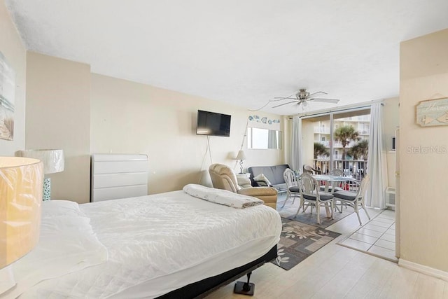 bedroom with ceiling fan, light wood-type flooring, and access to exterior