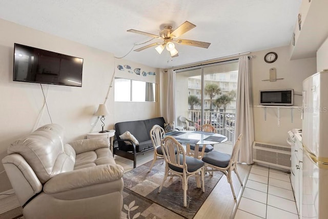 tiled living room with ceiling fan