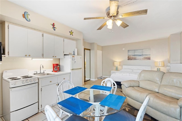 kitchen featuring ceiling fan, white appliances, white cabinets, and sink