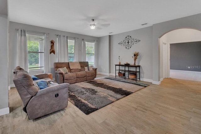 living room with ceiling fan and light wood-type flooring