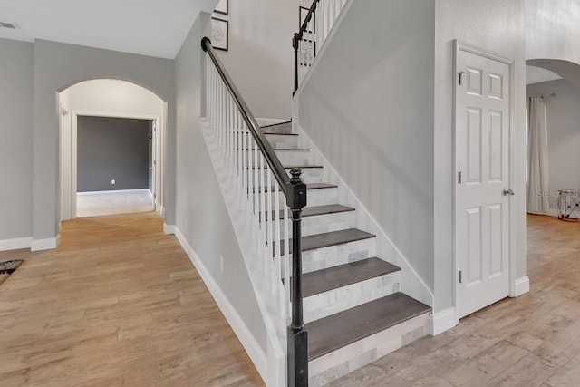 stairs featuring hardwood / wood-style flooring