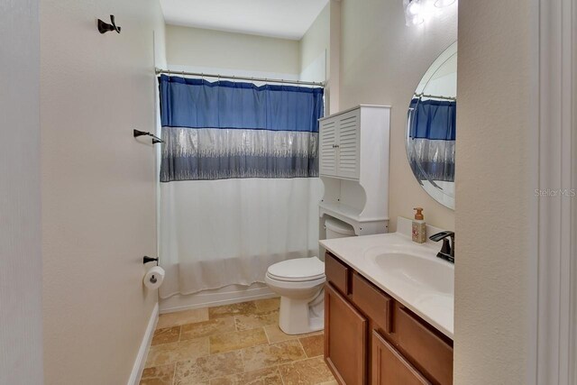 bathroom with tile patterned floors, vanity, and toilet