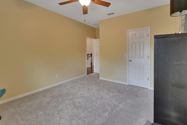 unfurnished bedroom with ceiling fan and carpet floors