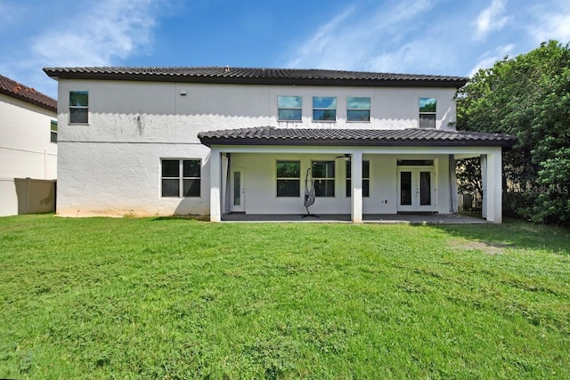 back of house with a patio area and a yard