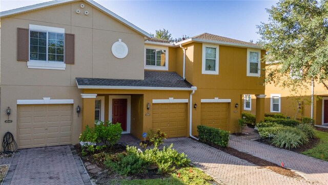 townhome / multi-family property featuring a garage