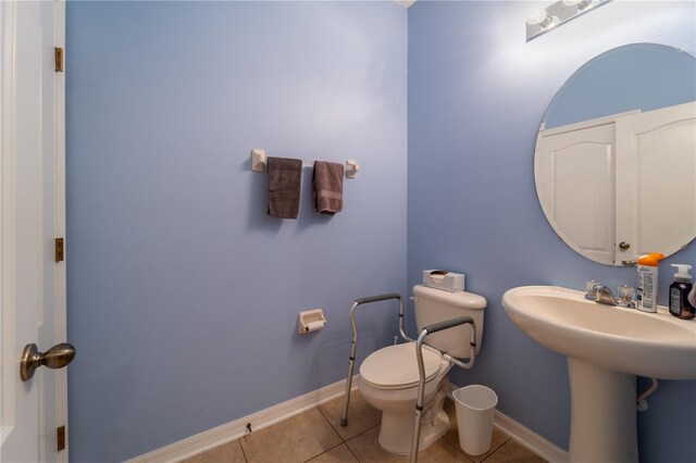 bathroom featuring tile patterned flooring and toilet