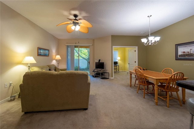 carpeted living room featuring ceiling fan with notable chandelier