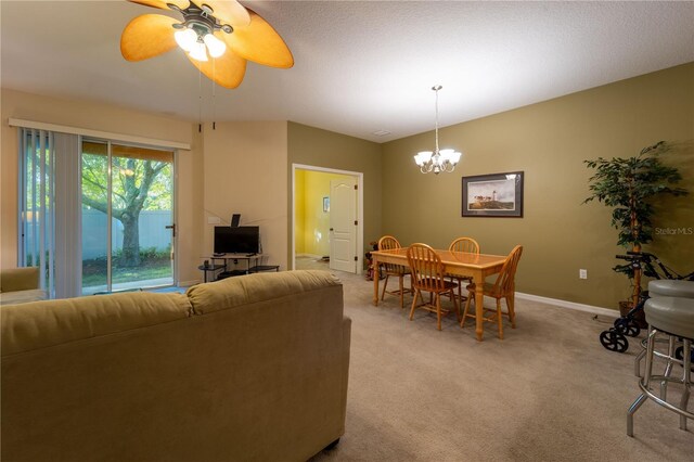 interior space with ceiling fan with notable chandelier