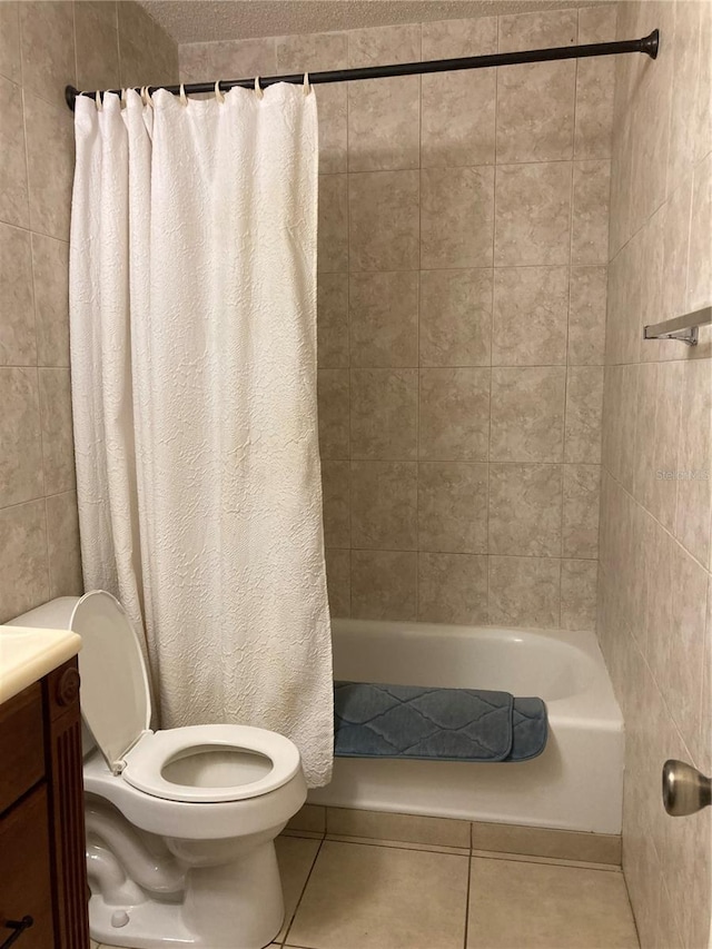 full bathroom featuring tile patterned flooring, toilet, vanity, and shower / bath combo with shower curtain