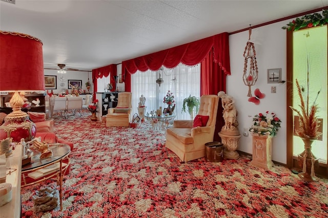 carpeted living room with ceiling fan