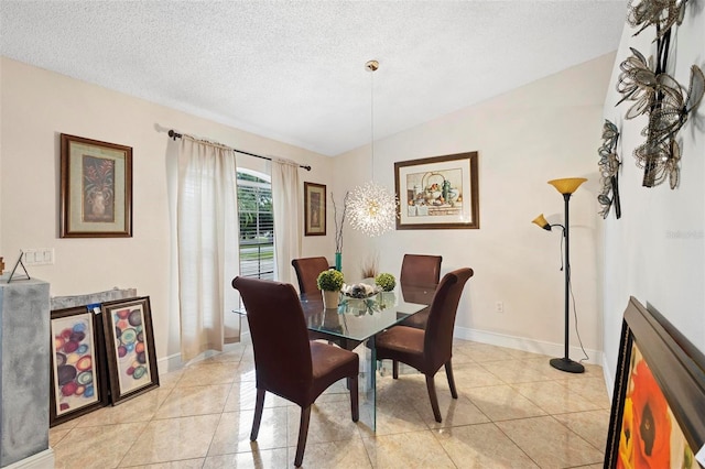 tiled dining area with lofted ceiling and a textured ceiling