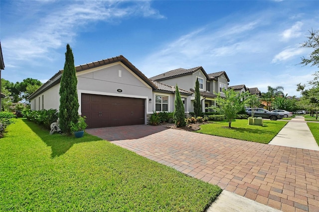 view of front facade featuring a garage, stucco siding, decorative driveway, and a front yard