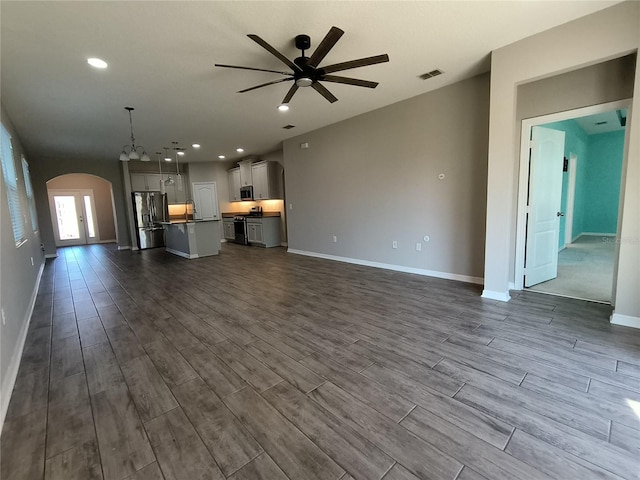 unfurnished living room with sink and ceiling fan