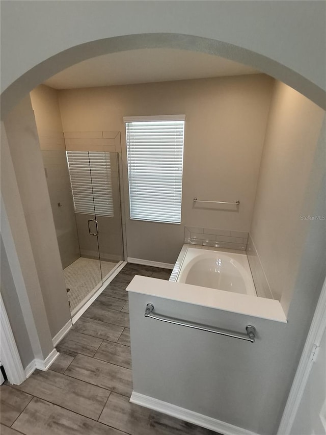 bathroom featuring independent shower and bath