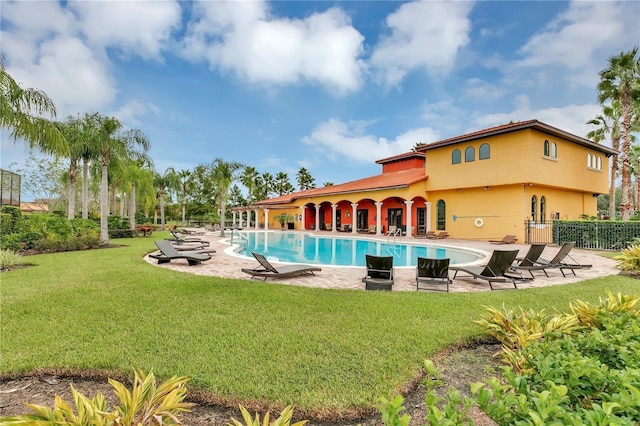 view of pool featuring a yard and a patio