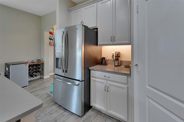 kitchen featuring stainless steel fridge, white cabinets, and stainless steel fridge with ice dispenser