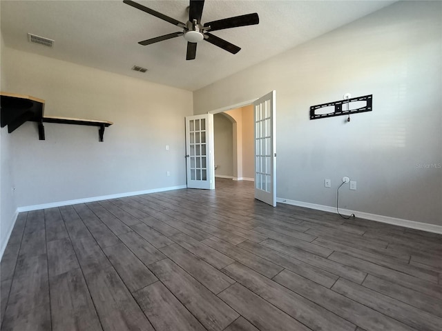 unfurnished room featuring ceiling fan, dark hardwood / wood-style flooring, and french doors