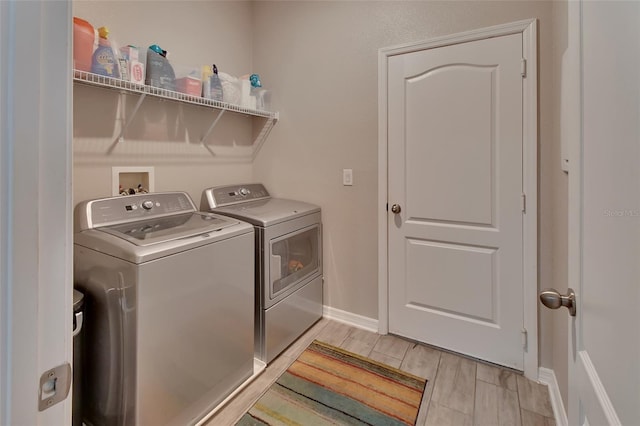 clothes washing area with washing machine and dryer